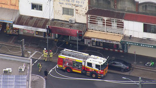 Car crashes into hair salon, bursts into flames on busy Sydney shopping strip