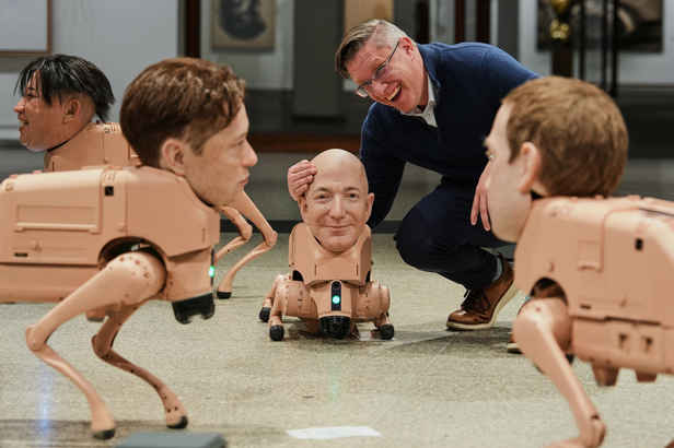 Robot dogs with Musk and Zuckerberg heads roam around gallery