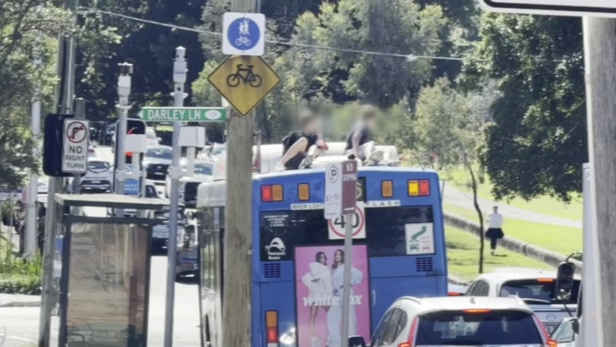 Teenagers who rode on bus roof sought by police