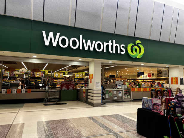 Woolworths sales up but supermarket cuts profit forecast amid petrol price spike